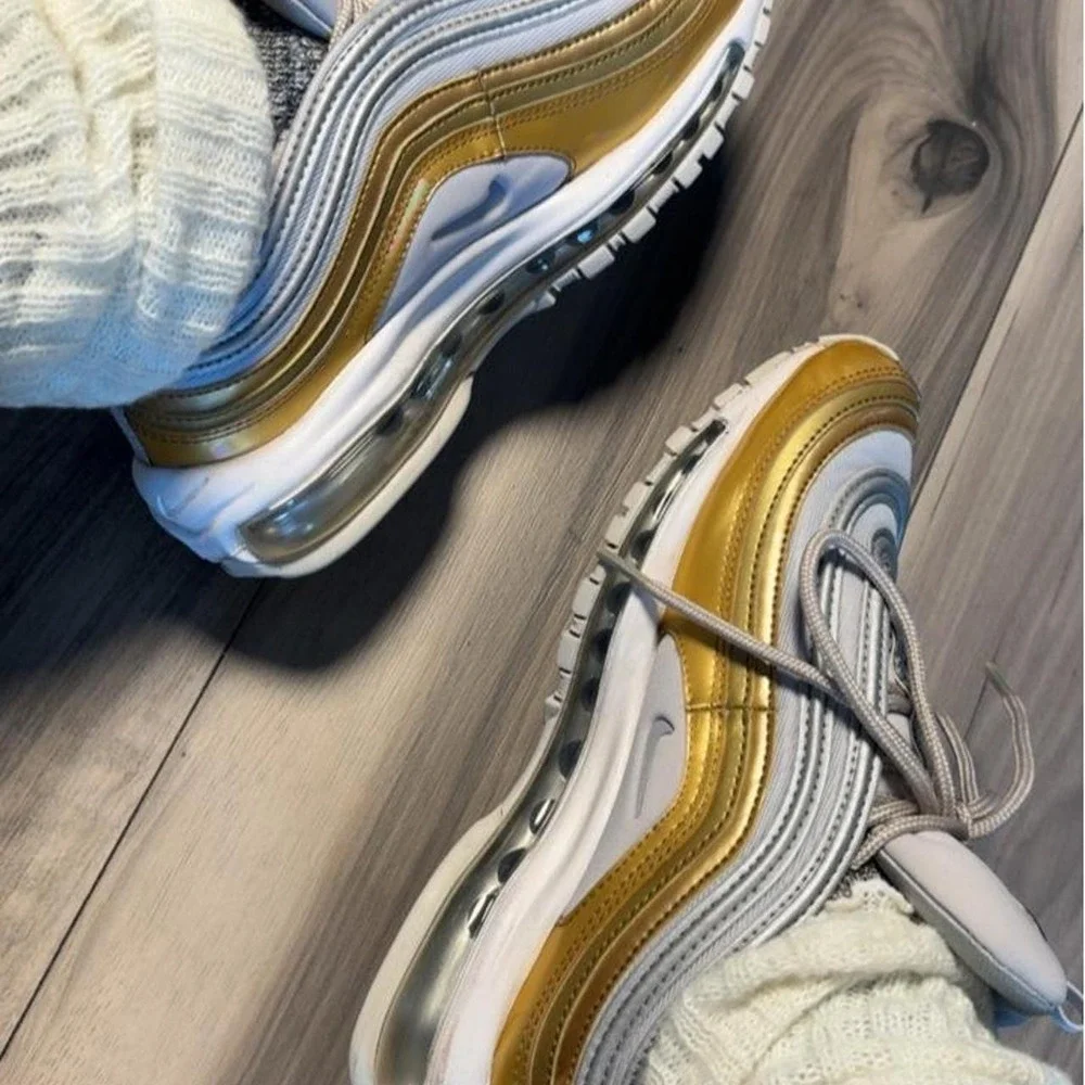Nike Air Max 97 sneakers in gold and white with silver accents